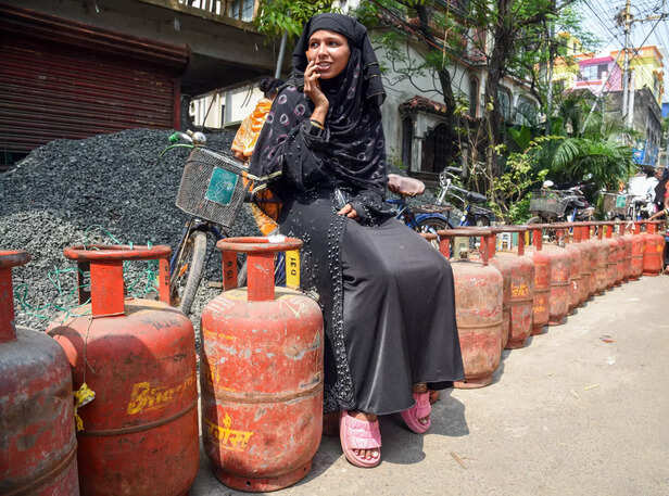 Kolkata, Mar 13 (ANI): A woman sits on top of one of the empty LPG cylinders in ...