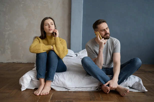 Couple sitting silently with emotional distance
