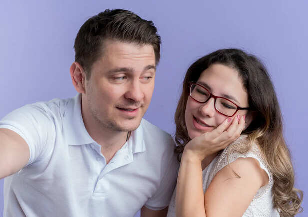 Smiling couple hiding emotional tension