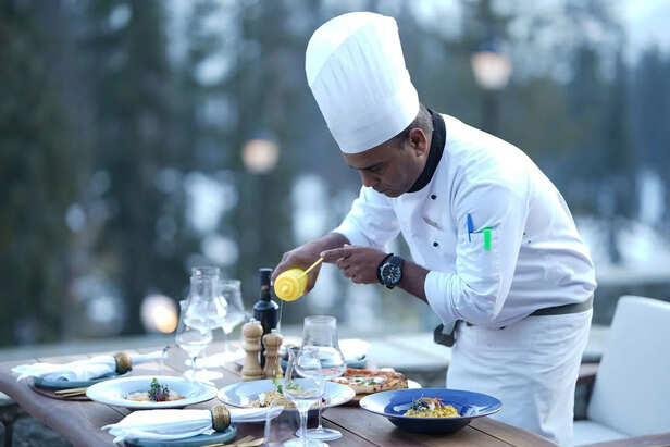 Chef Seasoning a Dish Before Serving