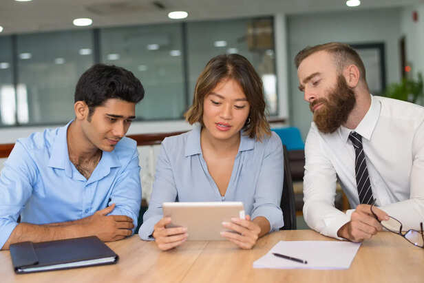 Employees Reading the Same Office Message