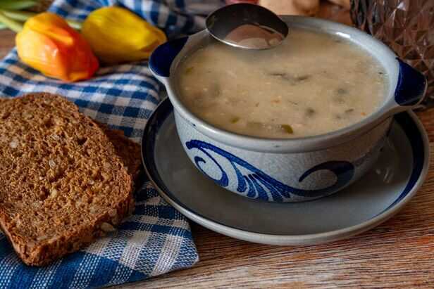 hot soup served beside bread on a rainy day