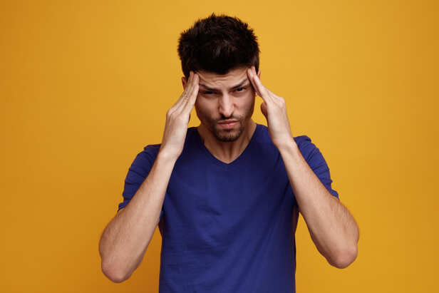 Person holding their head with severe headache