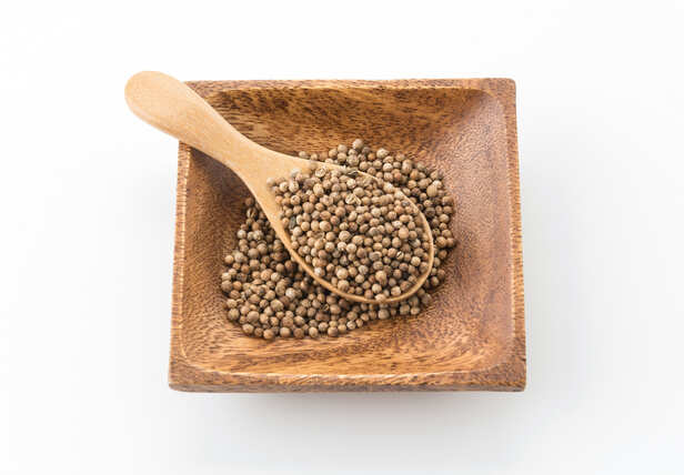 Coriander Seeds in a Wooden Bowl