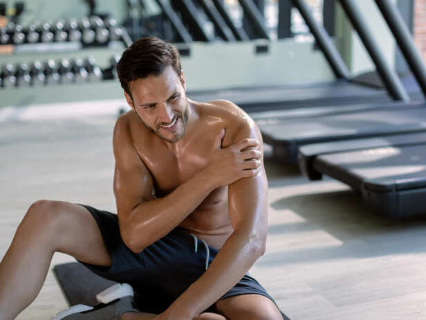 Gym-goer feeling pain during exercise