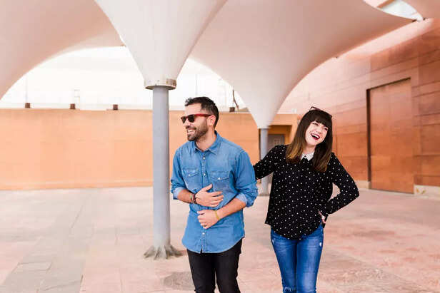 A couple laughing on a ca